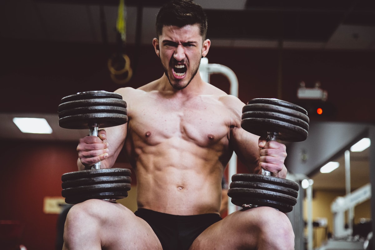 Athletic male performing strength training with proper protein nutrition